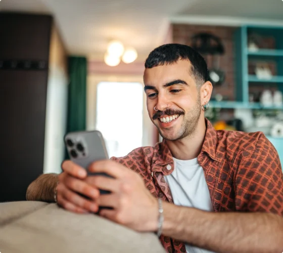 Employee smiling while reviewing care on their phone