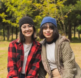 Two people smiling together outdoors