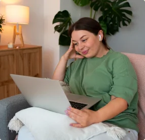 Person using a laptop comfortably at home