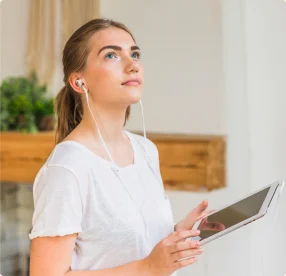Person thoughtfully reviewing care on a tablet